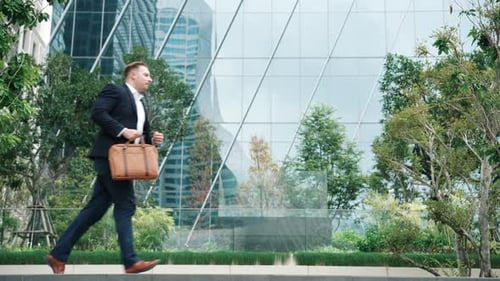 Side view of manager in hurry to be on time in appointment at eco park. Urbane.