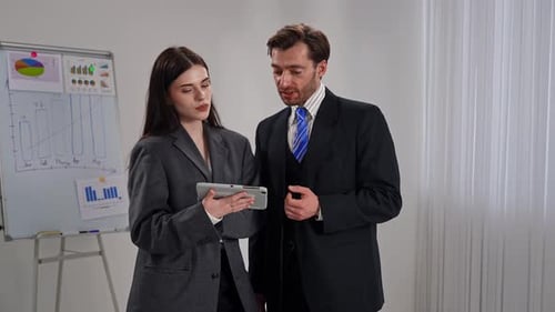 Business Professionals Discussing Data Insights in Modern Office