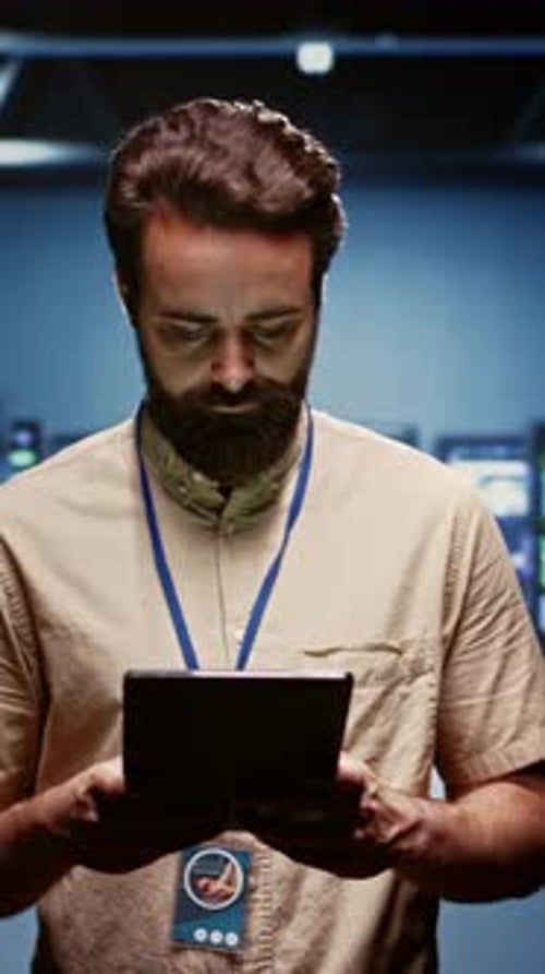 Man Using Tablet in Modern Server Room