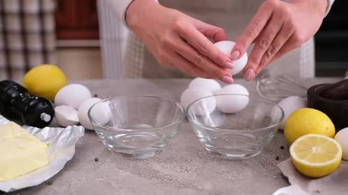 Adult Cracking Eggs on Counter