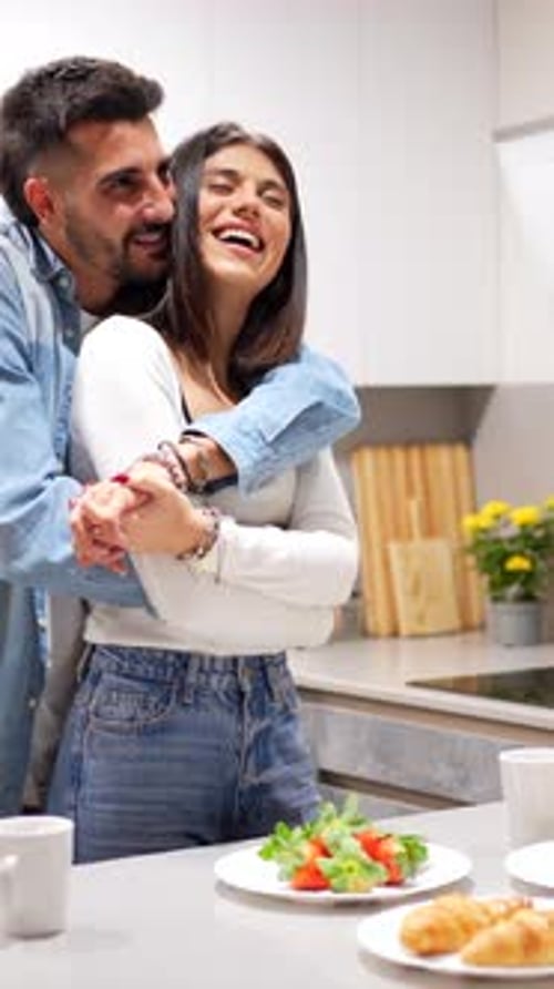 Affectionate Couple Embracing in Modern Kitchen