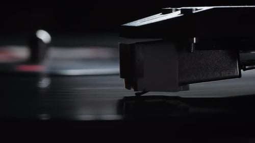 Record Player Needle on Vinyl in Dramatic Light