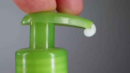 Fingers Pump Cream from Container, Close Up