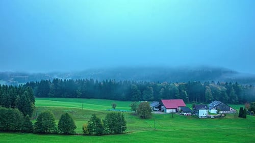 Central Alps, Austria, Europe - An Airplane Passed by the Small Mountain Settlement Enveloped in Low