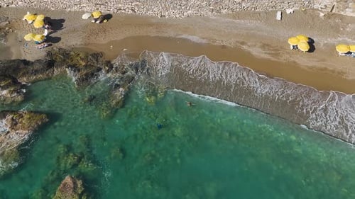 Aerial View Beautiful Model Posing on the Beach and Swimming in Blue Sea