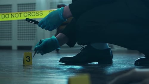 Crime Scene Investigator Examining Evidence with Magnifying Glass