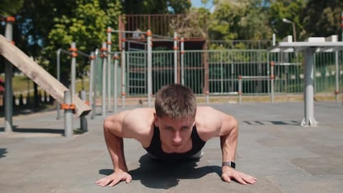 Muscular Man Doing Push-Ups Outside