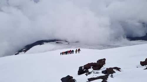 Group of Climbers are Walking in the Mountain Peak Mountaineering Team Climb Snowy Mountains for
