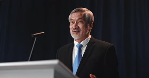 Man Giving Speech at Podium