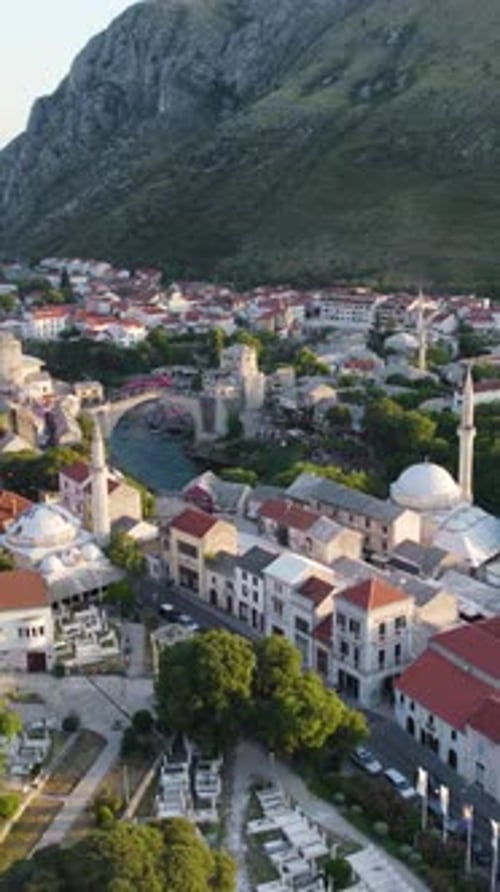 Stari Most illuminating Mostar cityscape in Bosnia and Herzegovina. Aerial, Vertical Video