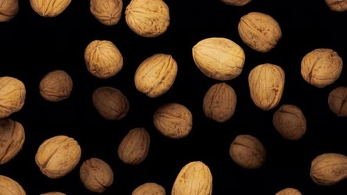 Walnuts Floating and Rotating on Black Background Loop