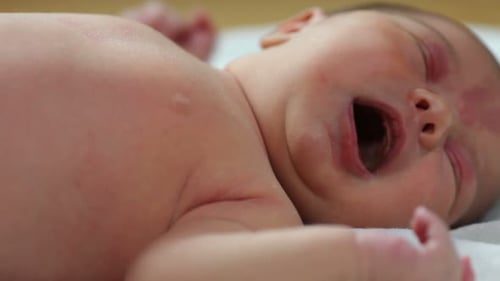 Newborn Infant Crying on White Cloth, Close Up