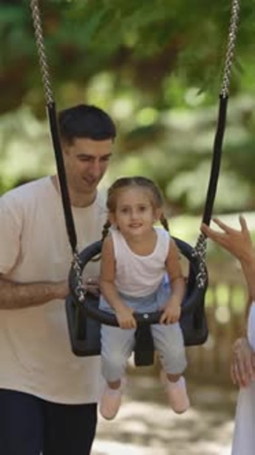 A Family Spending Time in the Park Smiling Happy Parents