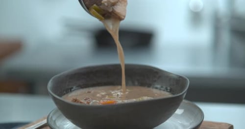 Hearty Beef Stew Being Ladled Into Ceramic Bowl Closeup in Ultra Slow