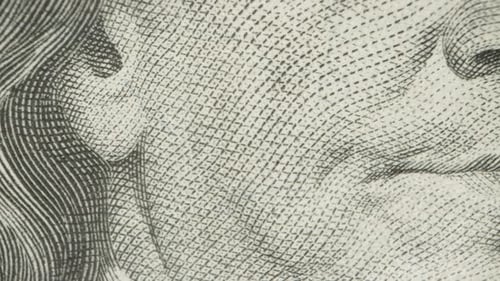 Portrait of Franklin on a hundred-dollar bill, nose and mouth. Dolly slider extreme close-up.