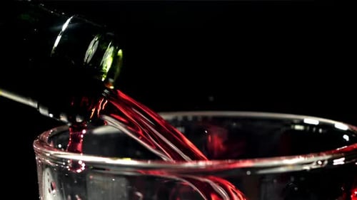 Red Wine Pouring Into a Glass on a Black Background Filmed on a Highspeed Camera at 1000 Fps