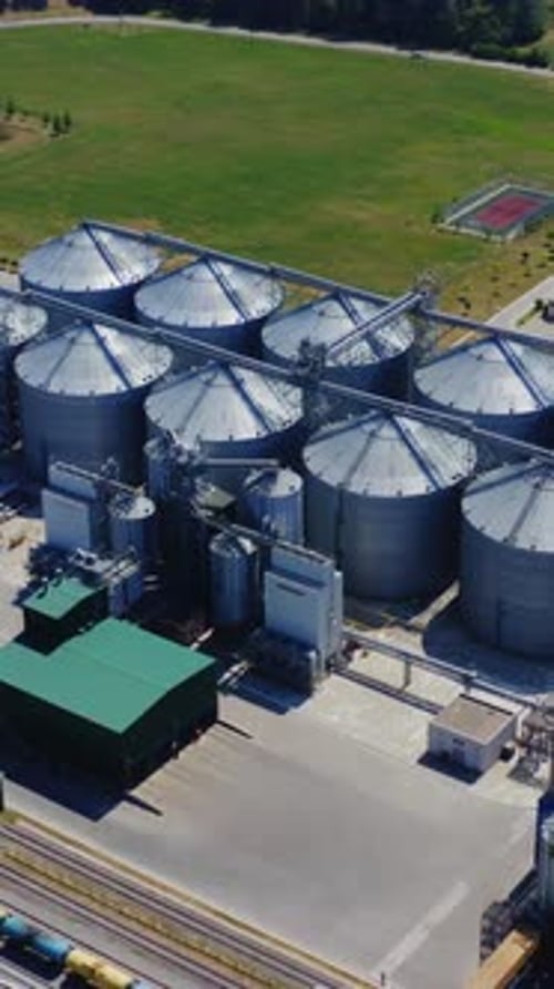 Industrial grain storage. Modern plant for agribusiness on field.