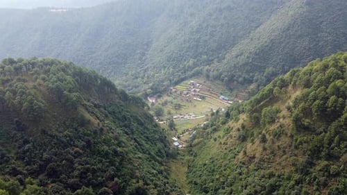 An aerial flight over the forested foothills of the Himalaya Mountains in Nepal.