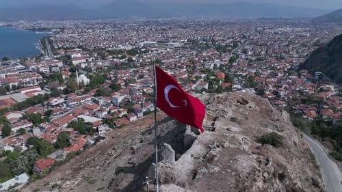 Turkish Flag Flies Above Ancient Ruins with City View
