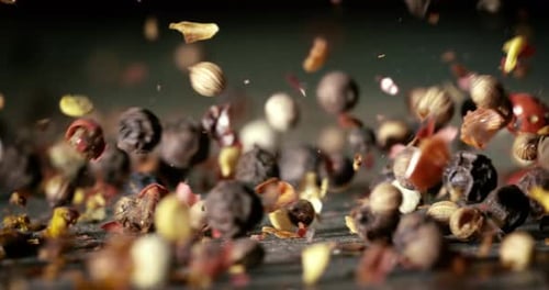 Mixed peppercorns in a super slow motion. Dry mix peppercorns close up.