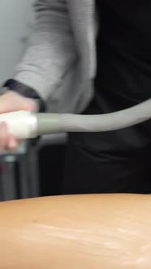 Woman Receiving Laser Hair Removal Treatment on Leg