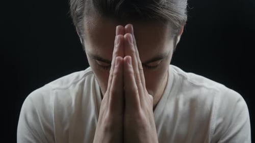 Close Up of Young Man Praying to God