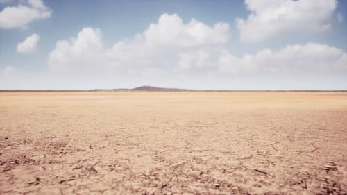 Panoramic View of Arid Cracked Earth under Blue Sky