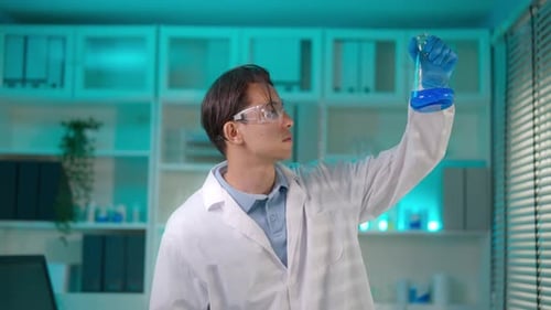 Asian male scientist working in the biotechnology research laboratory.