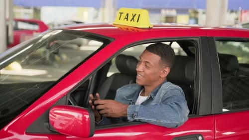 Smiling Taxi Driver with Money in Car