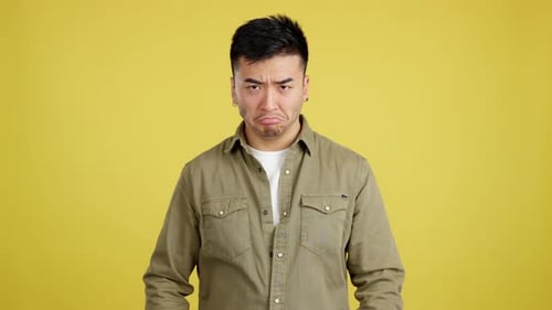 Chinese Man Crossing the Arms with an Angry Expression