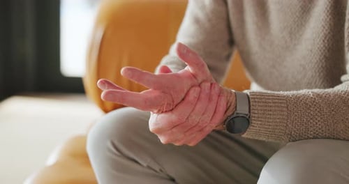 Man Massaging His Hand for Pain Relief