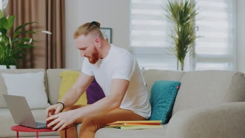 Man Working from Home on Laptop and Video Call