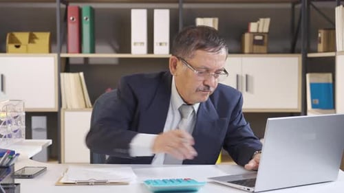 Man Works at Desk, Tears Up Paper