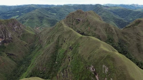 Ridge top hiking trail in remote steep rugged mountains, aerial view