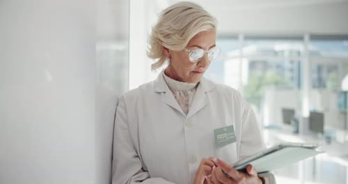 Mature Woman Working on Tablet in Medical Lab