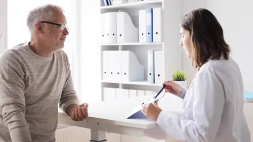 Medicine, Age, Health Care And People Concept - Senior Man And Doctor Meeting In Medical Office A...