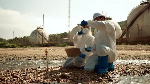 Scientists Sampling Water Pollution in Industrial Area