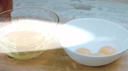 Separated Egg Whites and Yolks in Bowls