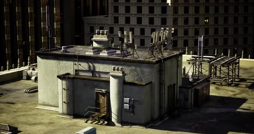 Communication Equipment on a Rooftop in a City During Late Afternoon