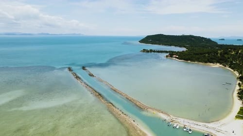 Aerial landscape with bay view. Moving over blue sea with green island on the right side. Cinematic