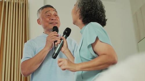 Senior Couple Singing Karaoke Together