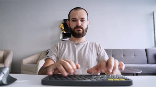 Man Typing on Keyboard at Home Office Desk