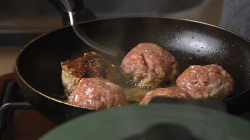Meat patties or cutlets in form of cutlets, fried in oil in pan,