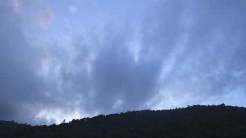 Storm Clouds Moving over Mountain Range at Sunset