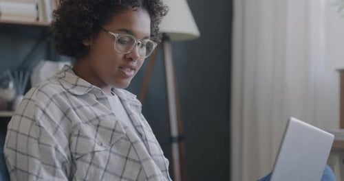African American Girl Student Studying Online with Laptop Enjoying Distant Education and Smiling in