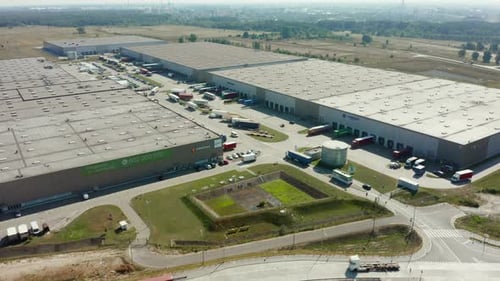 Aerial View of Logistics Park Warehouse with Trucks with Trailers