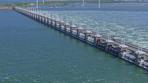 Aerial view of storm surge barrier and wind turbines, Netherlands.