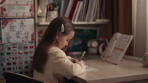 Girl Focused on Drawing in her Bedroom