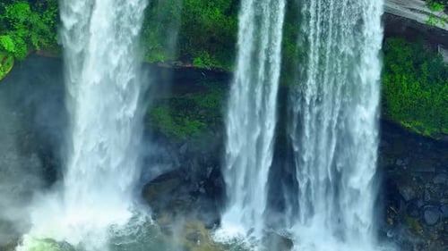 Aerial view over a waterfall in a beautiful tropical forest.