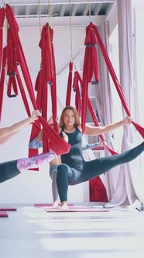 Modern Fly Yoga Zone with Women Standing in Warrior Asana